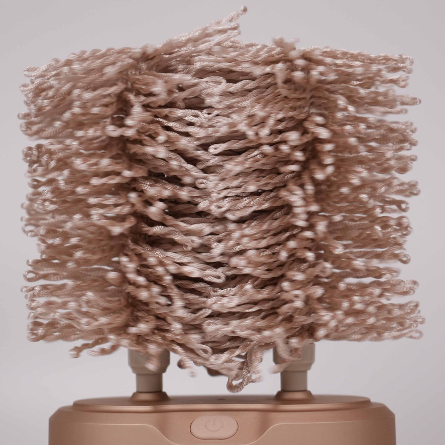 Closeup of a Sparkléve glass polisher spinning, showcasing the ultra-soft chenille microfiber brushes